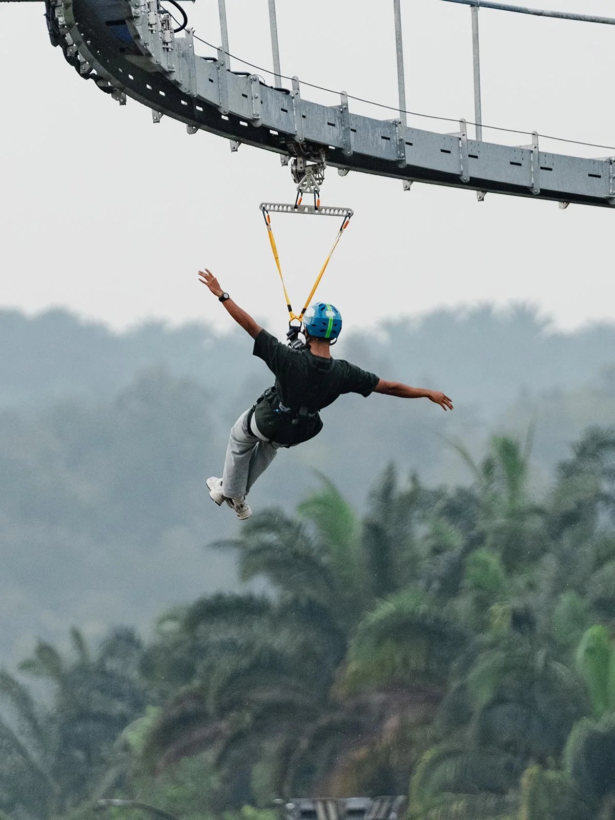 Skyline Luge Kuala Lumpur Hyfly Zipline Rider riding with arms spread wide