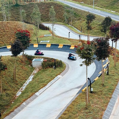 A couple racing round a corner on the Luge.