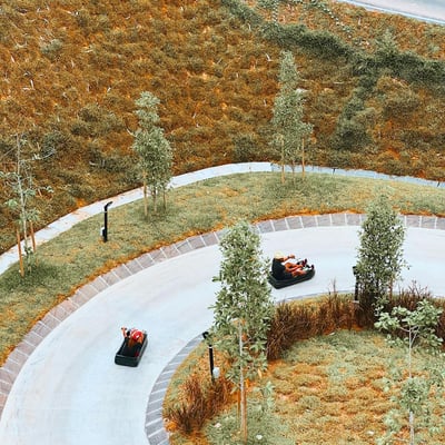 An aerial view of people Luging round a corner.