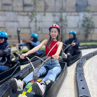 A lady rides the Luge tracks.