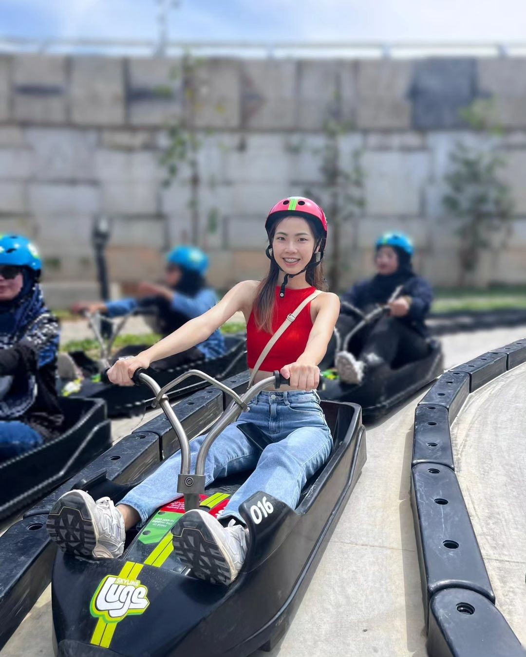 A lady rides the Luge tracks.