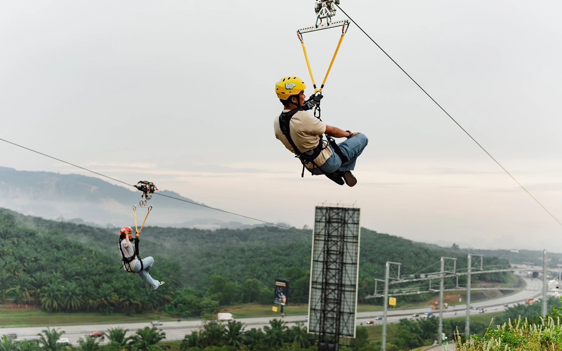 Skyline Luge Kuala Lumpur Guests riding the Hyfly Zipline with a vew of surrounding hills