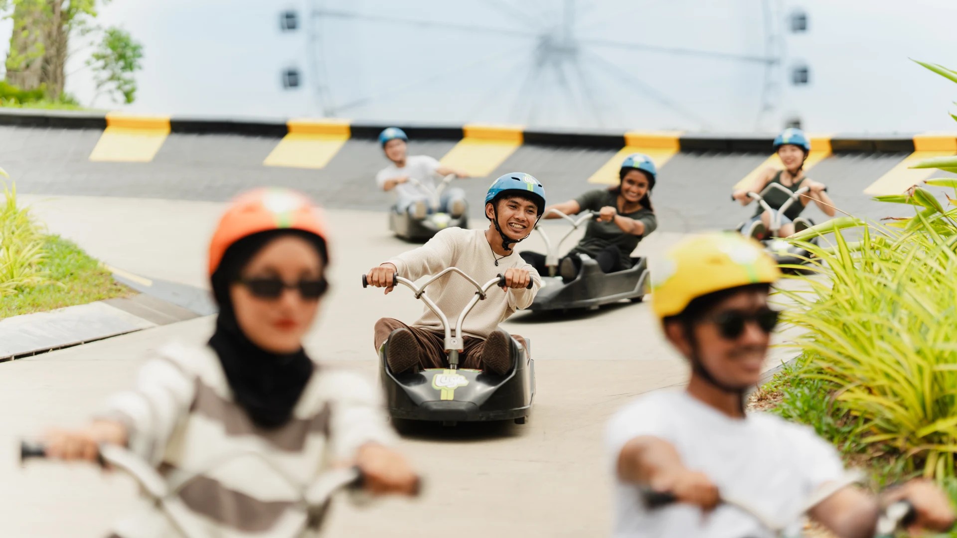 Skyline Luge Kuala Lumpur Man on Luge Cart riding with friends