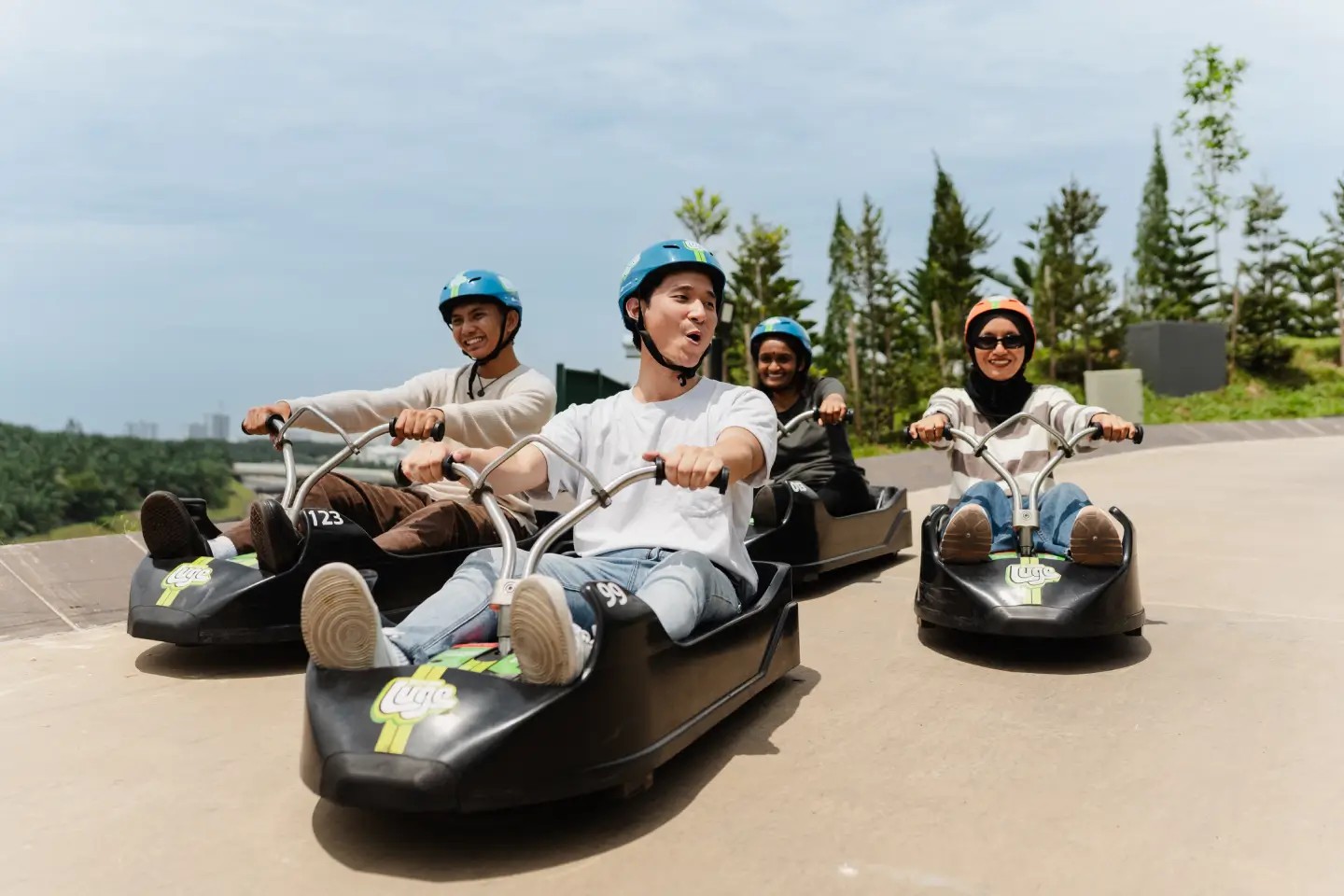 A group of friends ride the Luge together at Skyline Luge Kuala Lumpur.