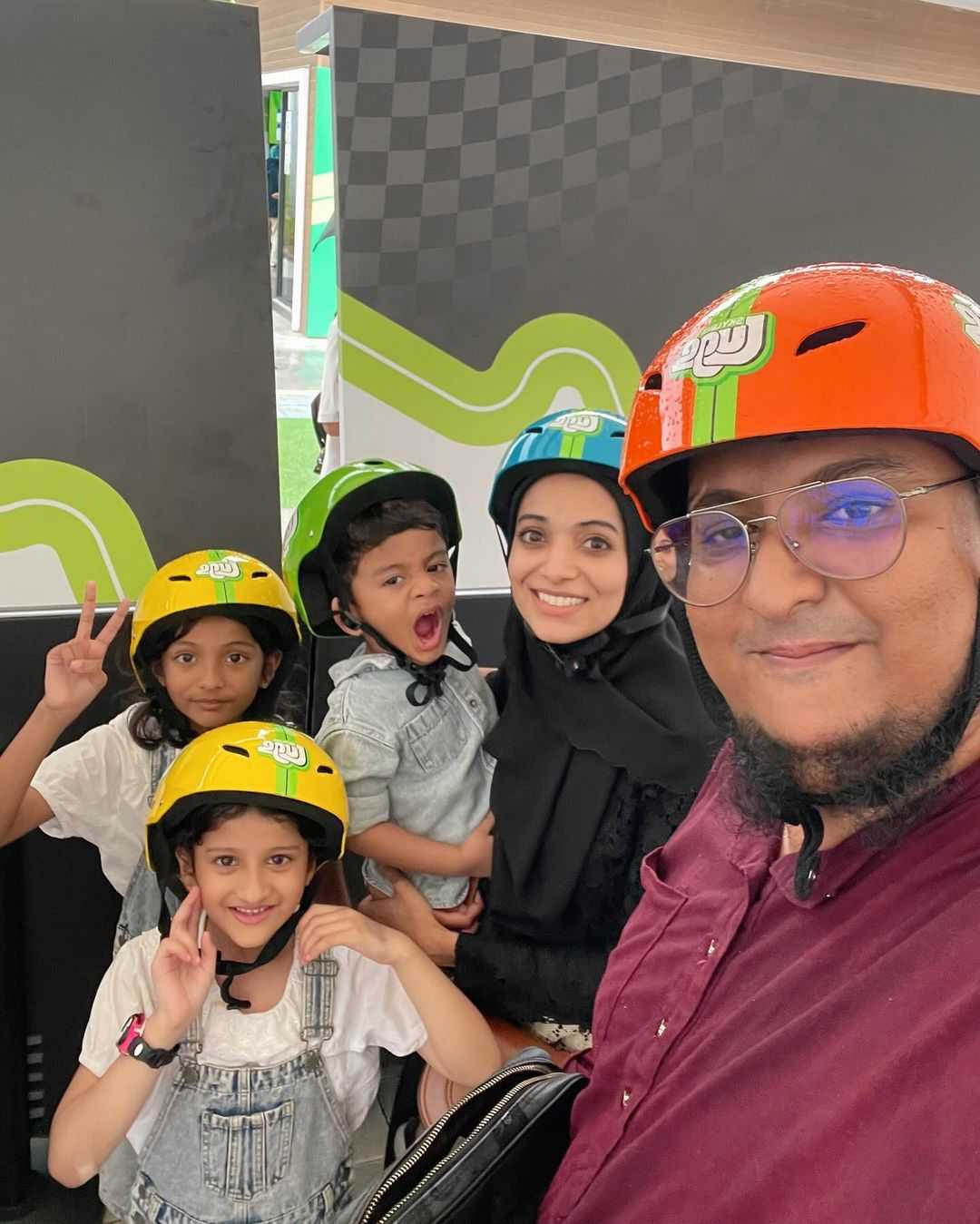 A group family photo with parents and kids all ready to go Luging.