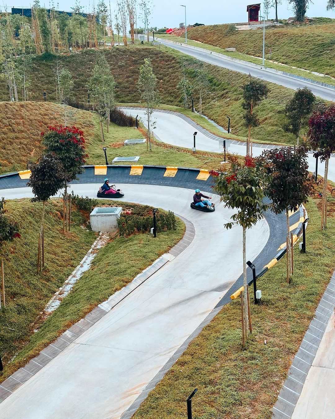 A couple racing round a corner on the Luge.