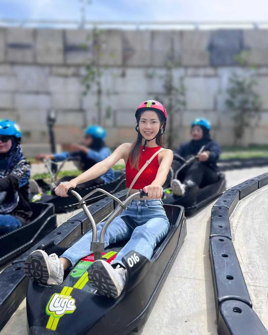A lady rides the Luge tracks.